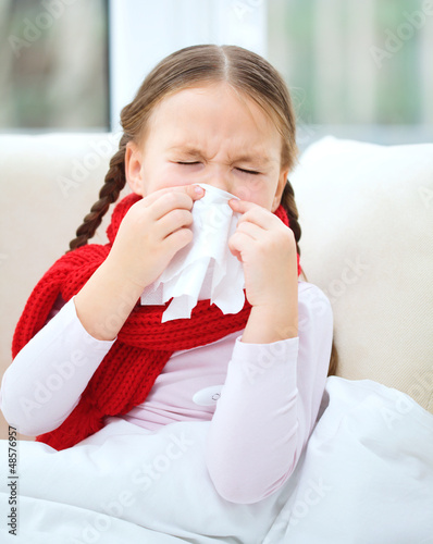 Photo: Little girl is blowing her nose Little girl is blowing her nose