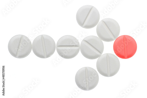 Photo: Arrow of white pills ending on red pill Arrow of white pills ending on red pill