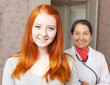   happy healthy teenager against doctor
