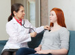 friendly doctor examining teenager patient