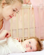 young mother and baby daughter at home