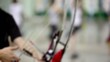 Few archers shoot in light room