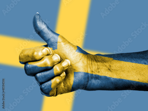 Photo: Old woman with arthritis giving the thumbs up sign, wrapped in f Old woman with arthritis giving the thumbs up sign, wrapped in f