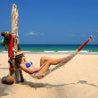 Woman in hammock on beach