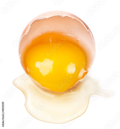 Photo: Egg yolk in the shell isolated on white background Egg yolk in the shell isolated on white background