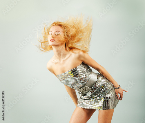 Photo: Dancing Woman in Silver Dress. Fashion Photo Dancing Woman in Silver Dress. Fashion Photo