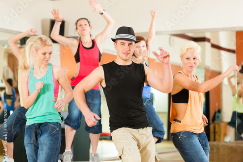 Photo: Zumba or Jazzdance - young people dancing in studio Zumba or Jazzdance - young people dancing in studio