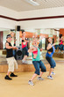 Zumba or Jazzdance - young people dancing in studio