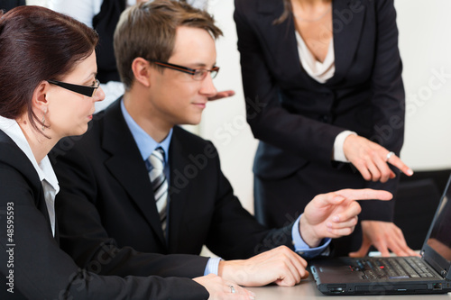 Photo: Business - businesspeople have team meeting in an office Business - businesspeople have team meeting in an office