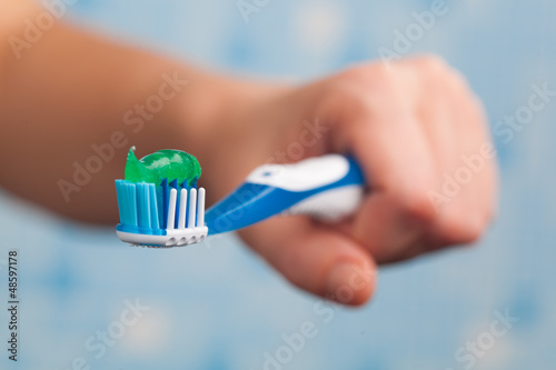 Photo: hand holding toothbrush hand holding toothbrush