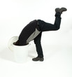Man puts his head in the trash