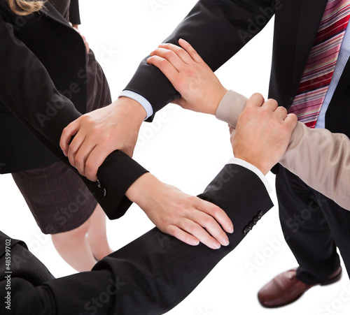 Photo: Businesspeople linking hands - teamwork Businesspeople linking hands - teamwork