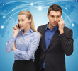 man and woman with cell phones