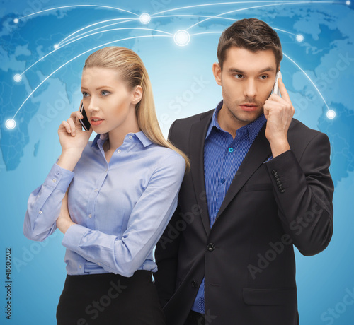 Photo: man and woman with cell phones man and woman with cell phones
