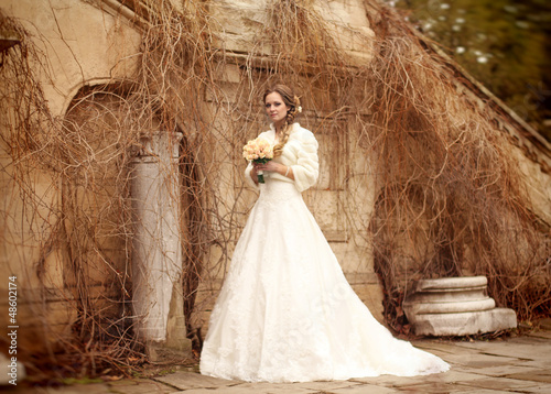 Photo: Bride beautiful woman in wedding dress - outdoor portrait Bride beautiful woman in wedding dress - outdoor portrait