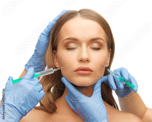Photo: woman face and beautician hands woman face and beautician hands