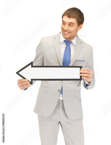 Photo: businessman with direction arrow sign businessman with direction arrow sign
