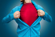 man pulling open shirt showing red t shirt