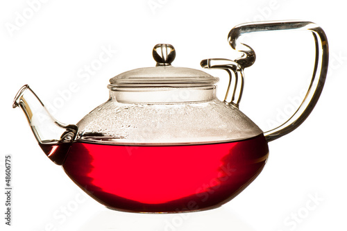 Photo: Fruits of the forest tea in glass teapot isolated over white bac Fruits of the forest tea in glass teapot isolated over white bac