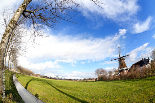 Photo: Dutch windmill on green pasture Dutch windmill on green pasture