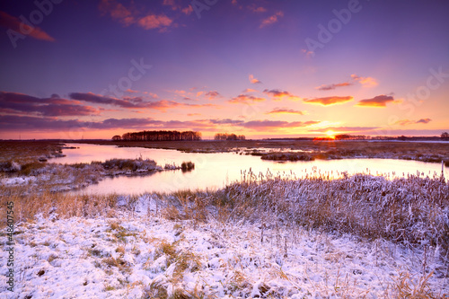 Photo: dramatic sunrise over frozen lake dramatic sunrise over frozen lake