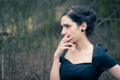 Photo: Portrait of a beautiful young woman smoking Portrait of a beautiful young woman smoking