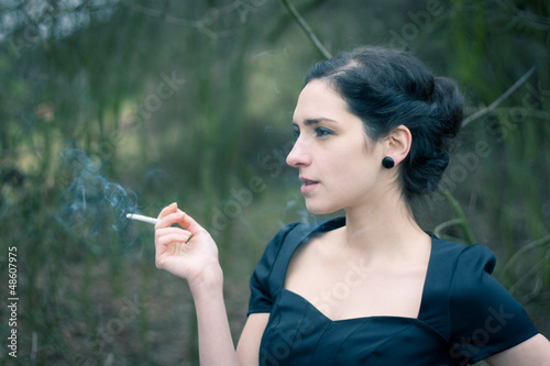 Photo: Portrait of a beautiful young woman smoking Portrait of a beautiful young woman smoking