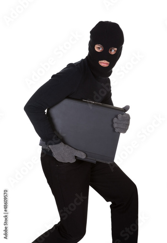 Photo: Thief stealing a laptop computer Thief stealing a laptop computer