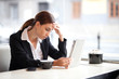 Stressed businesswoman working in a coffee shop. Selective focus