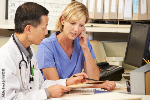 Photo: Doctor With Nurse Working At Nurses Station Doctor With Nurse Working At Nurses Station