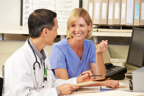 Photo: Doctor With Nurse Working At Nurses Station Doctor With Nurse Working At Nurses Station