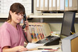 Photo: Nurse Making Phone Call At Nurses Station Nurse Making Phone Call At Nurses Station