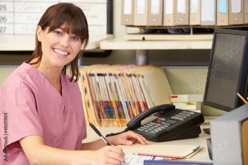 Photo: Nurse Working At Nurses Station Nurse Working At Nurses Station