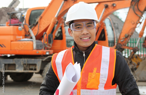Photo: road construction worker front of excavator road construction worker front of excavator