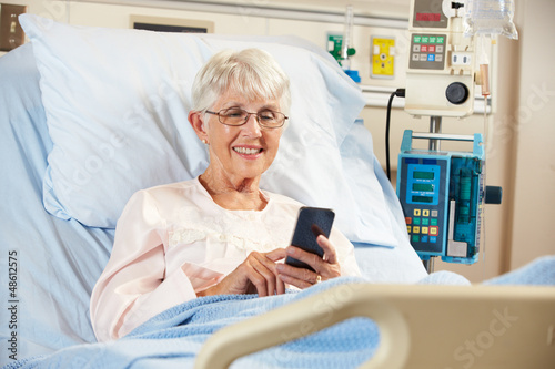 Photo: Senior Female Patient In Hospital Bed Using Mobile Phone Senior Female Patient In Hospital Bed Using Mobile Phone