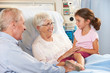 Granddaughter Visiting Grandmother In Hospital Bed
