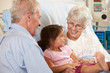 Granddaughter Visiting Grandmother In Hospital Bed