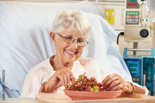 Photo: Senior Female Patient Eating Grapes In Hospital Bed Senior Female Patient Eating Grapes In Hospital Bed
