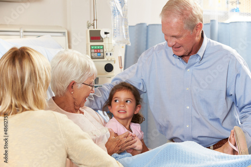 Photo: Family Visiting Senior Female Patient In Hospital Bed Family Visiting Senior Female Patient In Hospital Bed