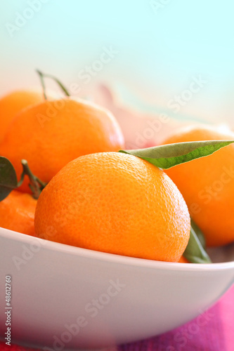 Photo: Ripe clementines in the bowl, close up Ripe clementines in the bowl, close up