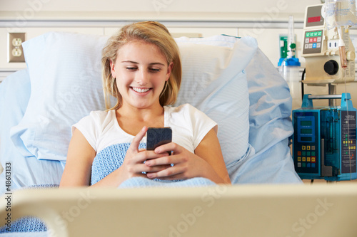 Photo: Teenage Female Patient Using Mobile Phone In Hospital Bed Teenage Female Patient Using Mobile Phone In Hospital Bed