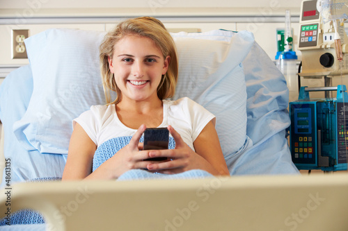 Photo: Teenage Female Patient Using Mobile Phone In Hospital Bed Teenage Female Patient Using Mobile Phone In Hospital Bed