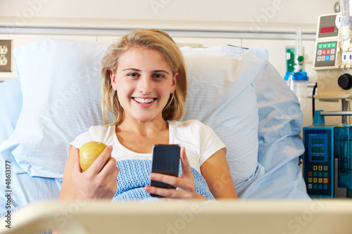 Photo: Teenage Female Patient Using Mobile Phone In Hospital Bed Teenage Female Patient Using Mobile Phone In Hospital Bed
