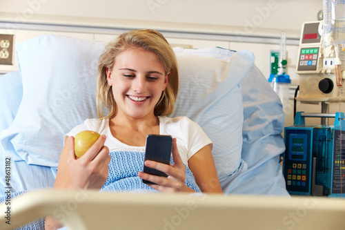 Photo: Teenage Female Patient Using Mobile Phone In Hospital Bed Teenage Female Patient Using Mobile Phone In Hospital Bed