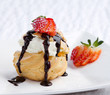Photo: Choux cream snack topping with strawberry on dish Choux cream snack topping with strawberry on dish