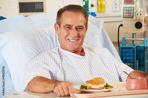 Photo: Male Patient Enjoying Meal In Hospital Bed Male Patient Enjoying Meal In Hospital Bed