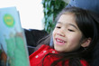 Child happily reading a book