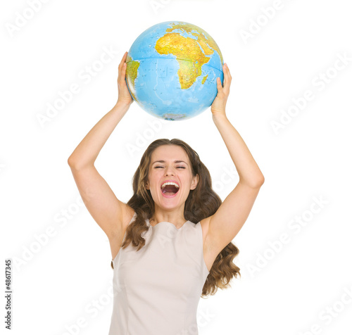 Photo: Happy young woman rising up globe Happy young woman rising up globe