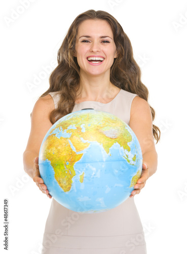 Photo: Happy young woman giving globe Happy young woman giving globe