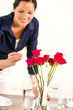 Foto: Happy woman lighting candle lunch guests dining Happy woman lighting candle lunch guests dining